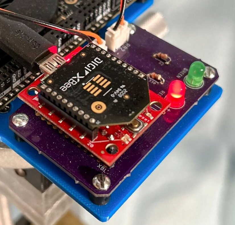 Zoomed in portion of focus adjusted photograph of emergency stop subsystem making legibility of PCB labels apparent.