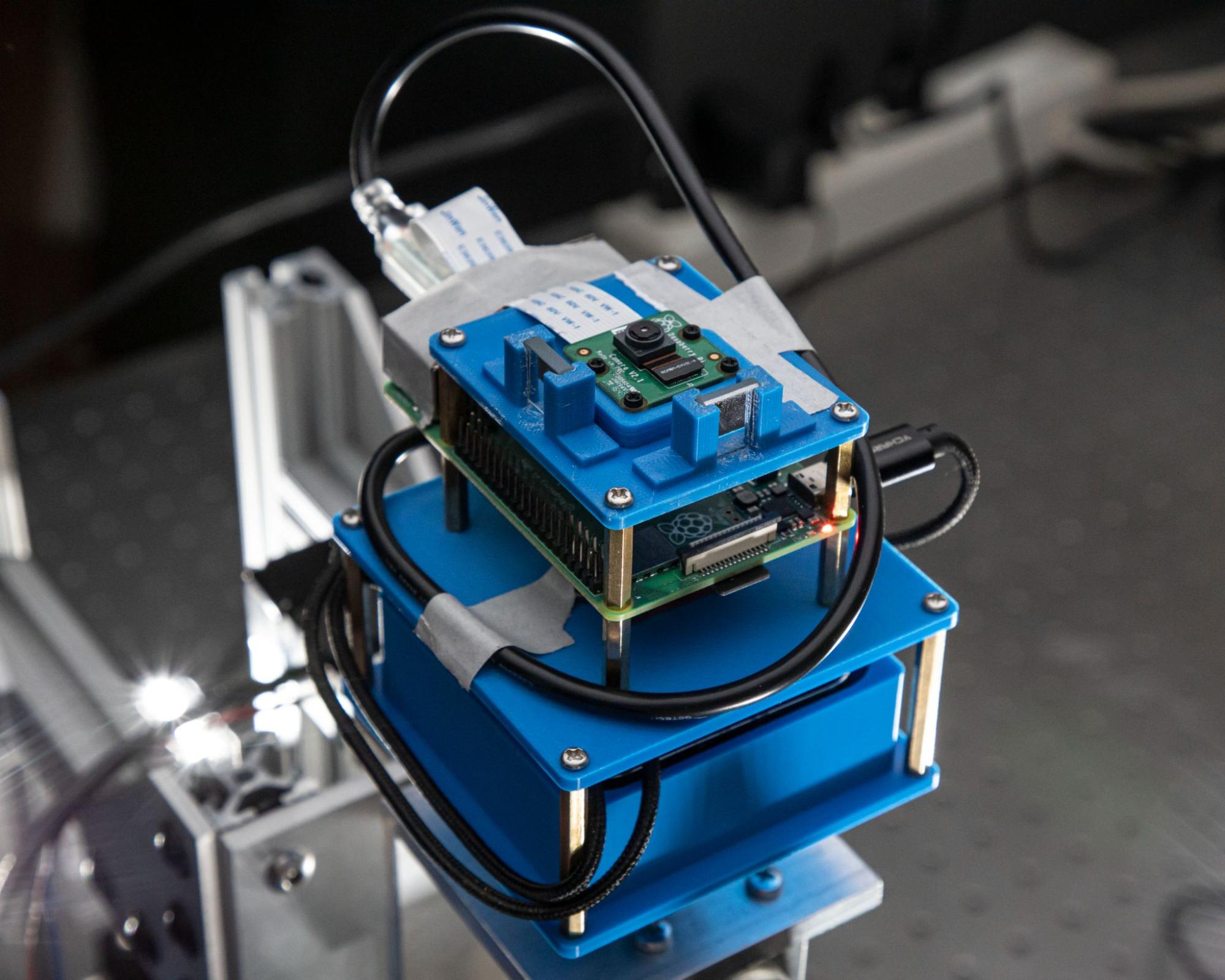 Closeup of camera subsystem that also shows mirrors used in an optical metrology subsystem.